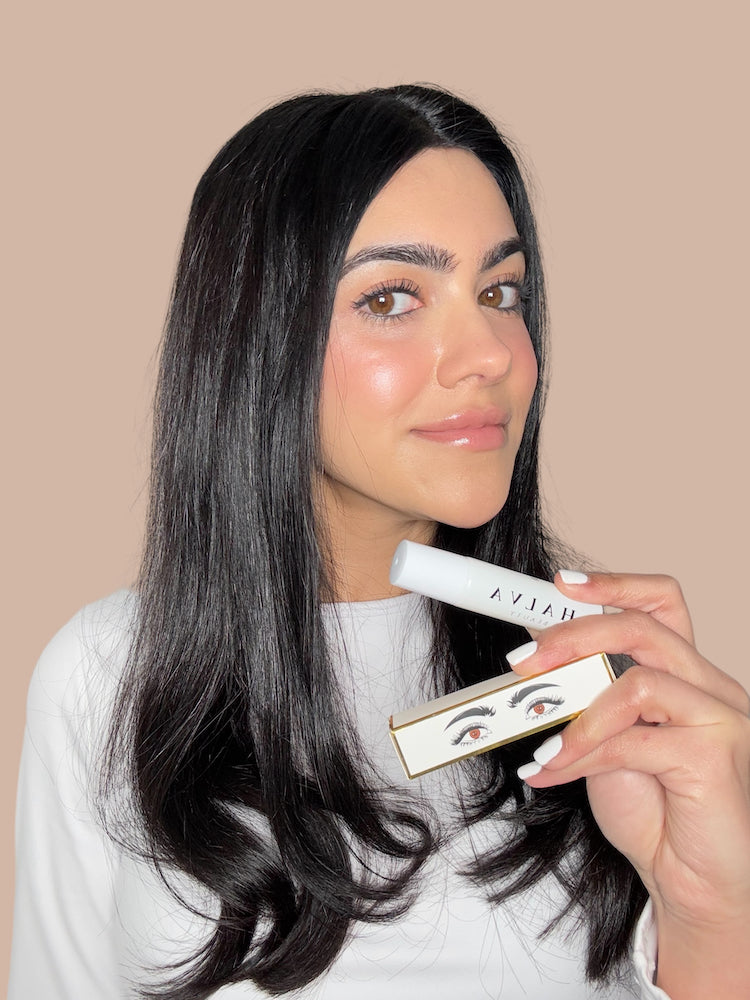 halva beauty founder holding nourishing brow oil and packaging — inspired by indian beauty rituals
