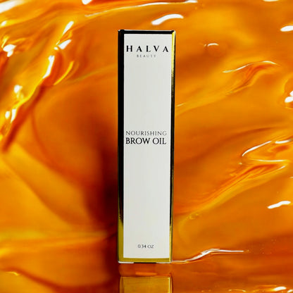 halva beauty nourishing brow oil and packaging on vibrant orange oil background