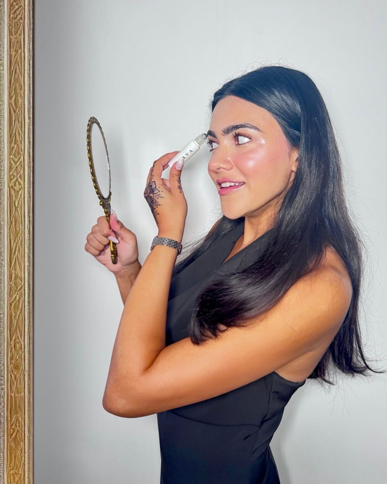 halva beauty founder applying brow oil 