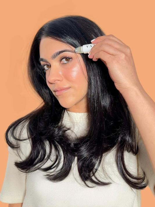 halva beauty founder applying brow oil for fuller brows