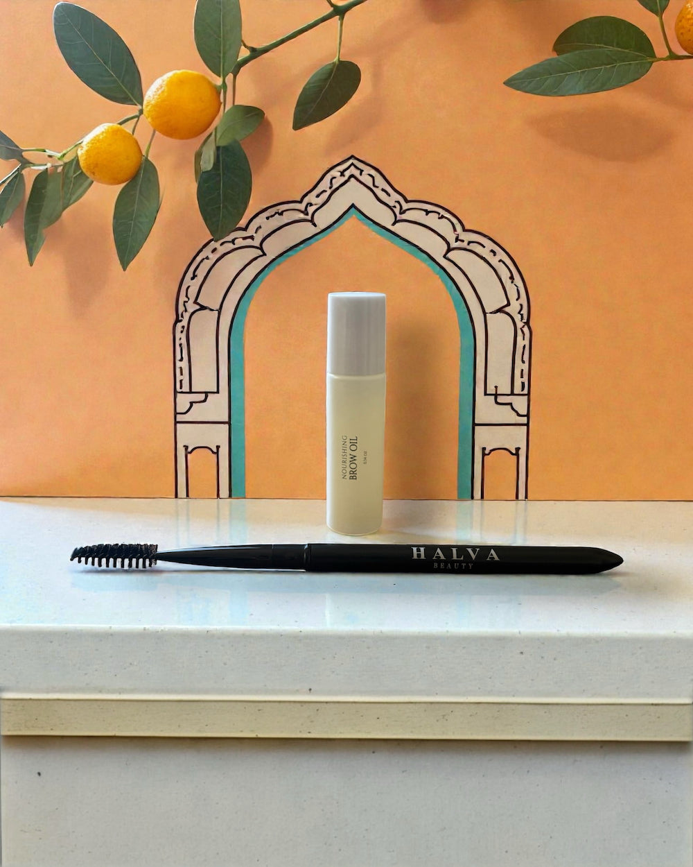 halva beauty nourishing brow oil and halva beauty spoolie displayed together as the halva beauty brow ritual set against an illustrated arch backdrop