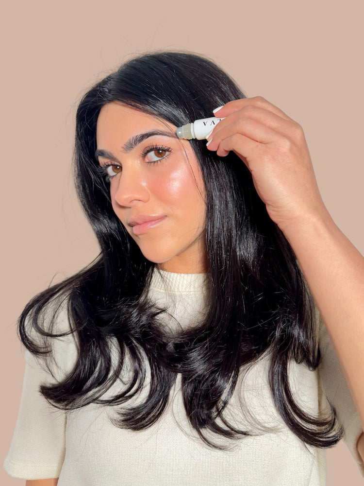 step 1: applying halva beauty nourishing brow oil with rollerball on clean brows